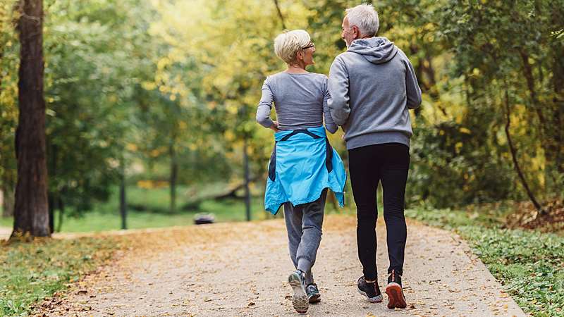 Older couple hiking in the woods