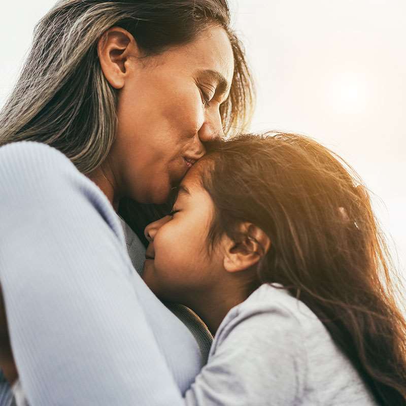 mother hugging daughter