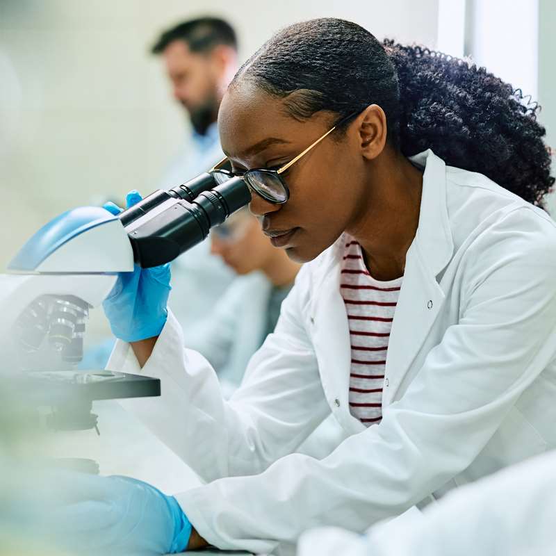 Student looking through microscope