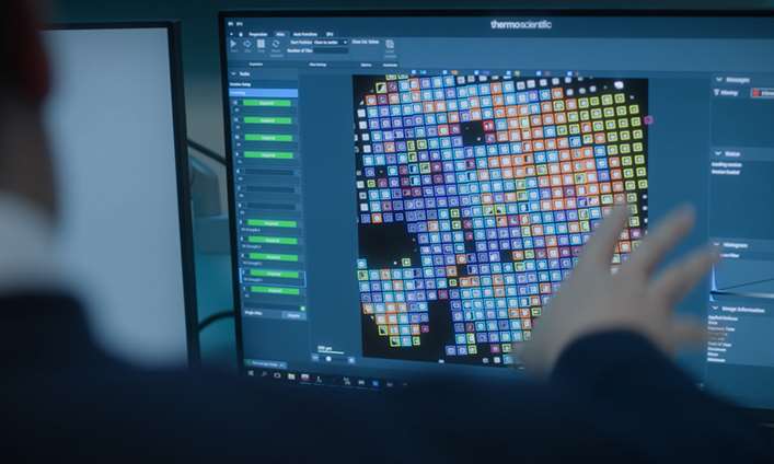 Researcher gesturing at computer display of Cryo Electron Microscopy