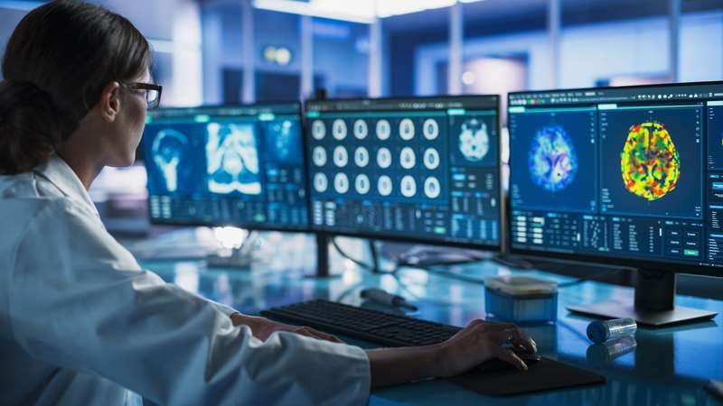 Medical professional viewing imaging from a PET MR scan