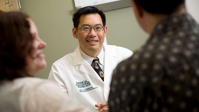 Two patients in discussion with a physician