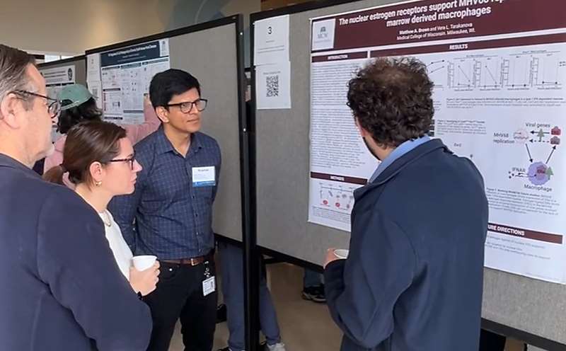 Attendees viewing poster session at trainee symposium