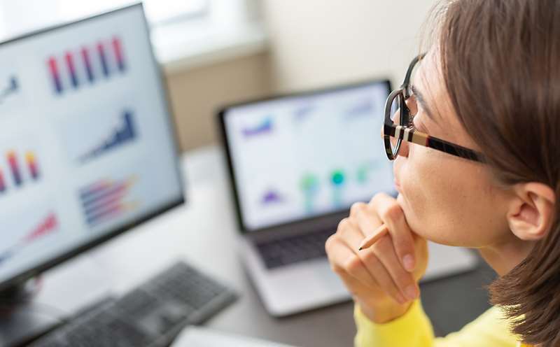 Researcher Looking at Statistics on Computer