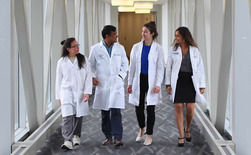 Researchers Walking in Hallway_Image Card Component