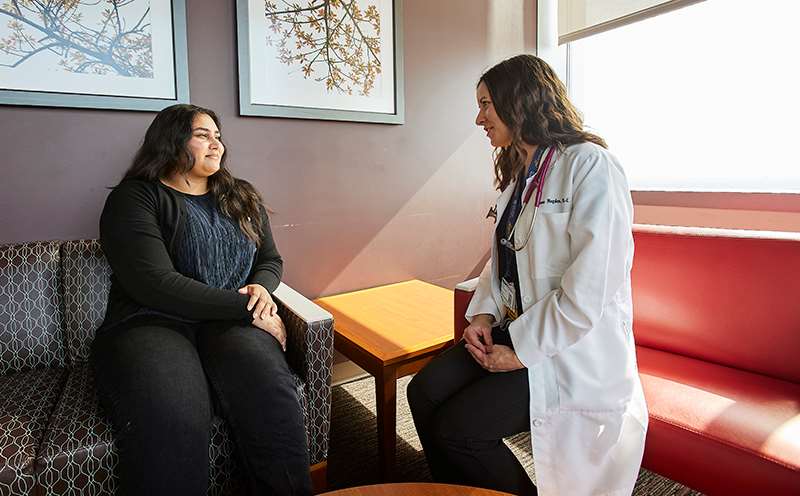 Female doctor consulting with female patient