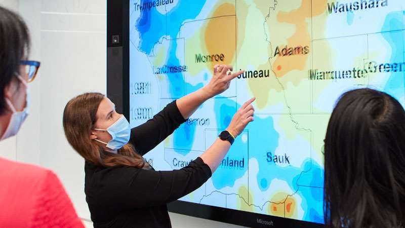 woman looking at geospatial cancer map